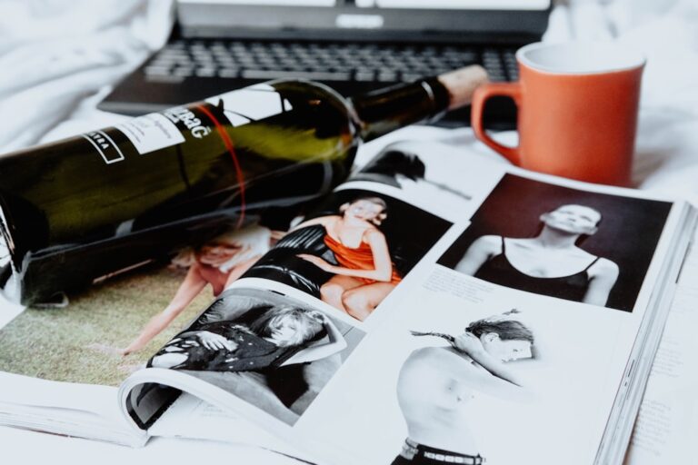 red and white ceramic mug beside black and white pen