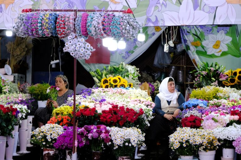 a group of women sitting in a flower shop