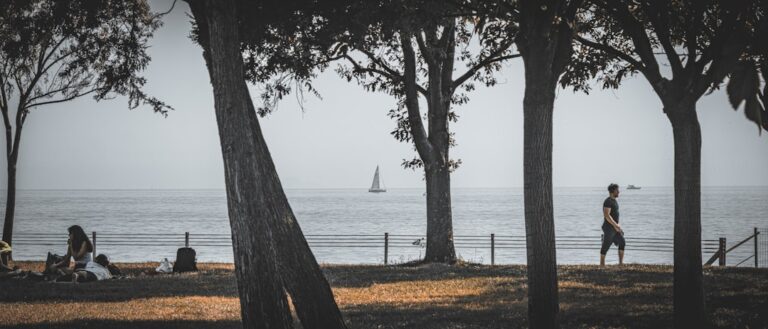 a couple of people that are standing in front of a body of water