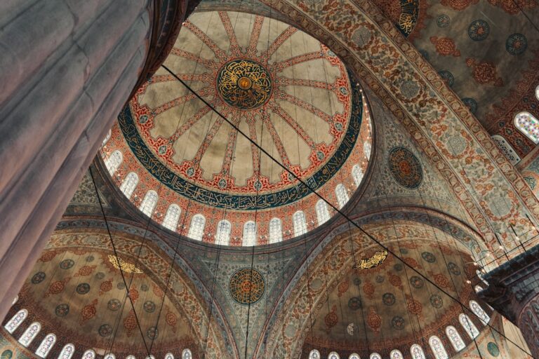 the ceiling of a large building with many windows