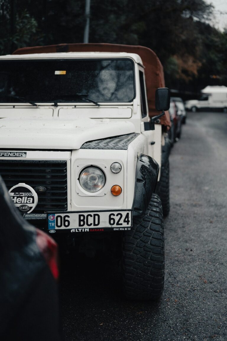 A white truck parked on the side of a road